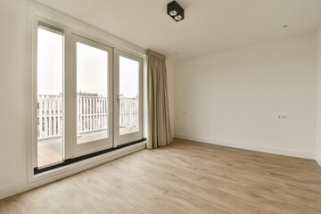 an empty room with wood floor and sliding glass doors looking out onto the balcony area in front of the house