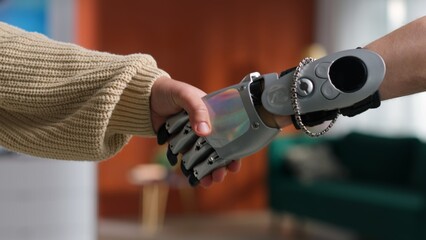 Cropped shot of man with prosthetic hand giving handshake female