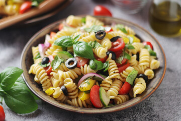 A bowl with traditional Italian pasta salad