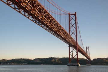 View of Ponte 25 de Abril Bridge at sunset, Lisbon, Portugal on the Tagus River