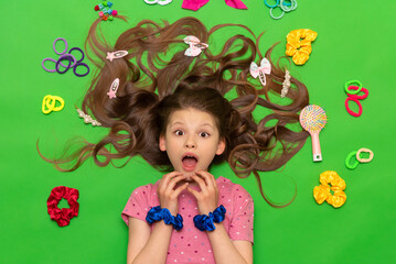 Accessories for children's hairstyles. A teenager with loose curly hair.  A little girl with...