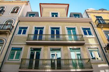 Lisbon, Portugal, facade of an old house with windows, European historical buildings, cozy cityscape, Portuguese streets landscape, view of city