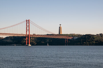 View of Ponte 25 de Abril Bridge at sunset, Lisbon, Portugal on the Tagus River	