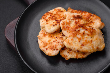 Delicious fried chicken meat chops with spices, salt and herbs