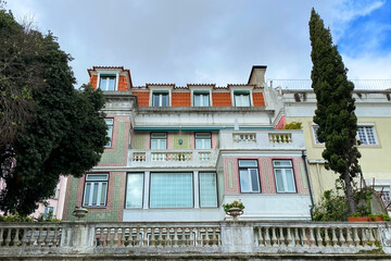 Obraz premium Lisbon, Portugal, facade of an old house with windows, European historical buildings, cozy cityscape, Portuguese streets landscape, view of city
