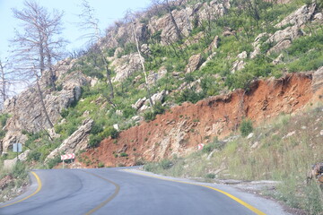 Picturesque asphalt road in the mountains of Turkey. Tourist transport and directions.