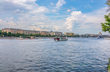 Naklejka premium Cruise ship sails on the Moscow river in Moscow city center, popular place for walking.