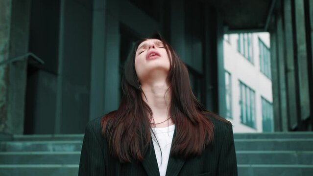 A frustrated woman outside, feeling the weight of her jobless situation and the struggle to make ends meet. Depressed caucasian business Woman urban city