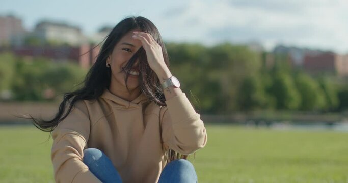 Close-up happy young teen latina college student in a park