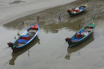 Fototapeta na wymiar Colorful wooden boats in shallow water, peaceful seascape, Asian landscape