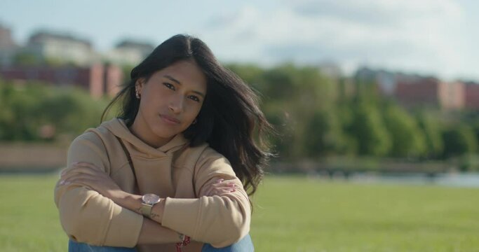 Close-up worried young teen latina college student in a park