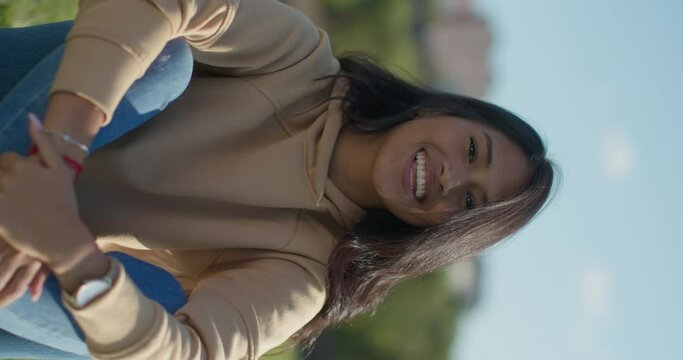 Close-up happy young teen latina college student in a park, vertical shot