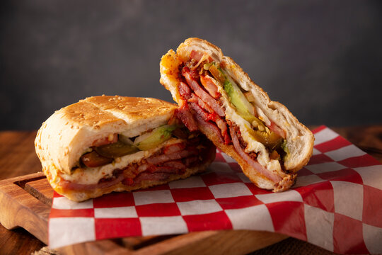 Mexican Torta. Sandwich made with common bread in Mexico, it can be telera, bolillo or bagette, split in half and filled with various ingredients, in this case spicy pork leg with Oaxaca cheese.