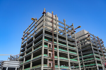 building construction site, hoisting cranes and new multi-store buildings