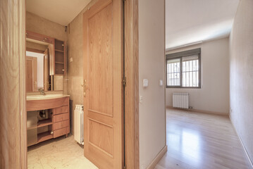 A room with an en-suite bathroom furnished with an integrated mirror