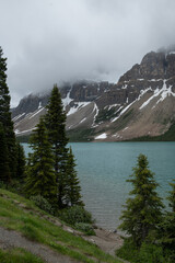 Beautiful turquoise lake with snow covered peaks above it in Banff National Park of Canada