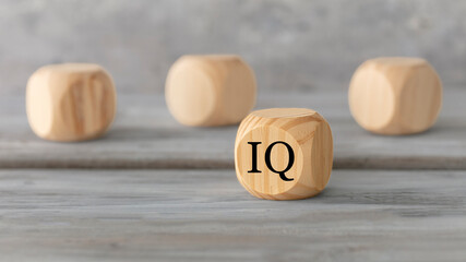 IQ, intelligence concept. Abstract geometric wooden dice isolate with a IQ icon on white rustic...