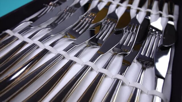 motion around old case with set of elegant silver cutlery