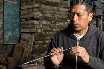 Precision in Action: Blacksmith Calculating and Straightening Metal Rod