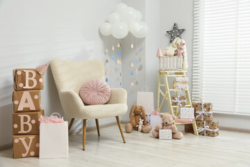 Baby shower party. Festive decor, gift boxes and toys in stylish room