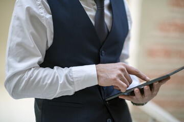 Fototapeta premium business person working with laptop and tablet in the office, talking on the phone and evaluating work