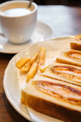 Katsu sando japanese sandwich with breaded pork chop, cabbage and tonkatsu sauce in a cafeteria.