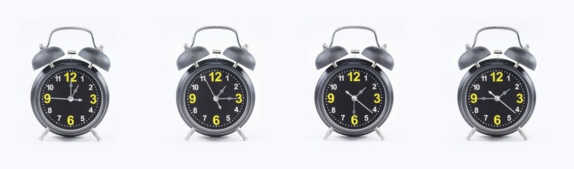 close up of a set of black alarm clocks showing the time; 1, 1.15, 1.30 and 1.45 p.m dan a.m. Isolated on white background
 - obrazy, fototapety, plakaty