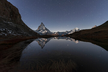 Matterhorn reflection in Riffelsee lake in a starry night, Gornergrat, Zermatt, canton of Valais, Swiss Alps, Switzerland