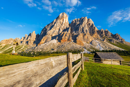 Mountain hut in green meadows under the massif of Sass de Putia at sunset, Passo delle Erbe, Dolomites, Puez Odle, Bolzano district, South Tyrol, Italy