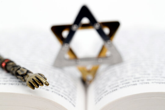 Close-up detail of a Torah in Hebrew, Star of David and a yad, Jewish symbols, France