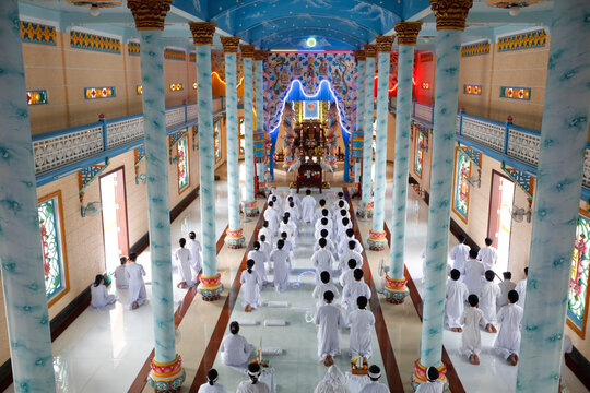 Cao Dai temple, Caodaist worshippers at ceremony, Tan Chau, Vietnam