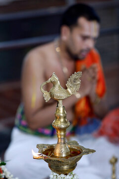 Sri Srinivasa Perumal Hindu temple, Hindu priest (Brahmin) performing puja ceremony and rituals, oil lamp, Singapore