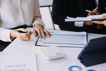 A couple is approaching a housing project to buy, and they are discussing details and advice with a salesperson in a housing project. Real estate trading ideas with couples.