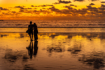 View of couple at sunset on Kuta Beach, Kuta, Bali