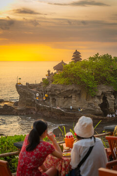 Tourists at Tanah Lot, traditional Balinese temple at sunset, Beraban, Kediri, Tabanan Regency, Bali