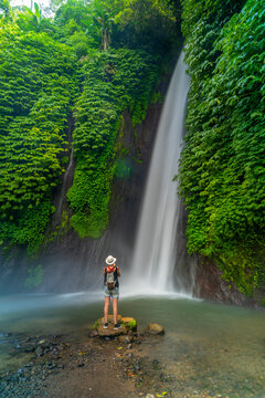 View of woman taking picture at Melanting waterfall, Kabupaten Buleleng, Gobleg, Bali