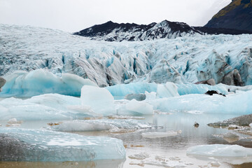 Glacier in Iceland, Pure Blue Ice at Winter Season, Frozen Beautiful Nature Landscape in North Europe Country. Global Warming and Climate Change Concept. Vatnajokull Glacier