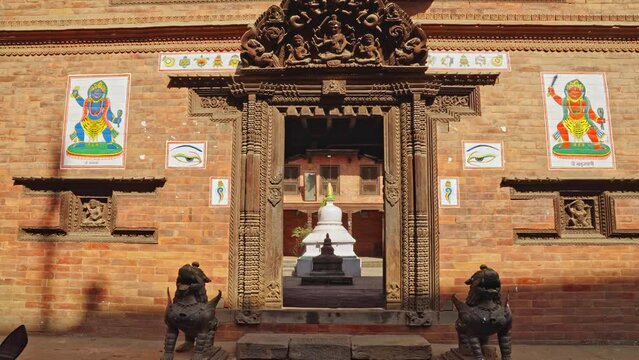 Moving into the doorway entrance to an ancient Buddhist monastery in Bhaktapur, Kathmandu Valley, Nepal