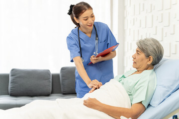 Medical personnel visit female patient lying in bed to inquire about symptoms