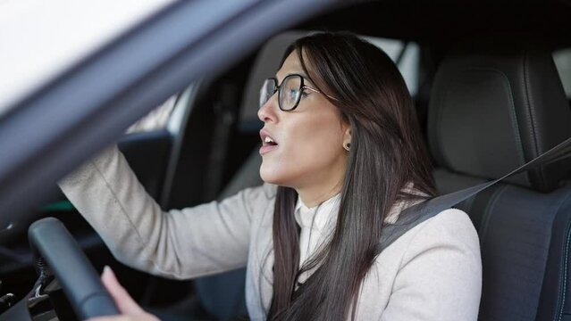 Young beautiful hispanic woman stressed driving car at street