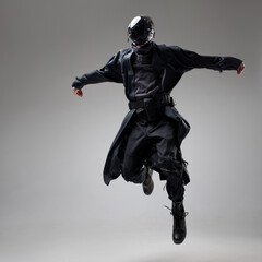Urbantech outfit cyber style, a young man in stylish black clothes and a mirror mask on his whole...