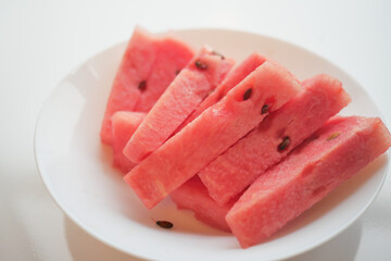 close up of slice of water melon on white background .