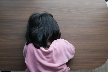 top view of child head down on desk 