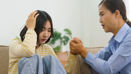 Female psychologist touching hands to comforting and encourage stress patient suffering depression - obrazy, fototapety, plakaty