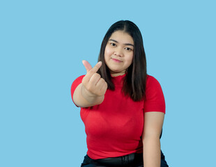 Portrait girl young woman asian chubby fat cute beautiful pretty one person wearing a red shirt is sitting smiling enjoy happily looking wow to copyspace imaginary on the blue background
