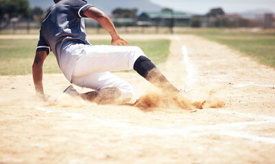 Baseball player, running slide and man on a base at a game with training and dirt. Dust, sport and male athlete outdoor on a field with exercise and run to safe box of runner on sand with competition