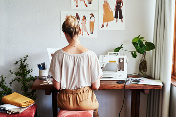 Fashion, design and back of woman at sewing machine in small business, creative ideas and focus in...
