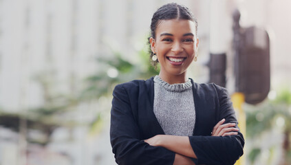 Portrait, business and woman with arms crossed, city and smile with confidence, career and consultant. Face, female person and employee outdoor, professional and skills with happiness or entrepreneur © Ruan B/peopleimages.com