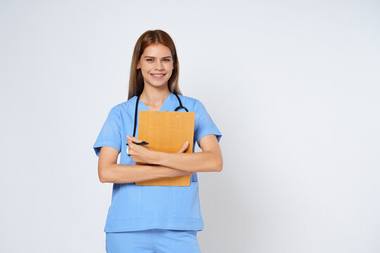 Smiling woman doctor holding clipboard and stethoscope isolated on white background.