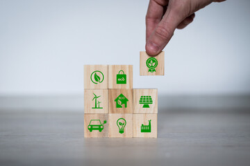 Net zero action concept. Save energy, green energy, reduce carbon footprint, carbon capture. Climate neutral long term strategy. Limit global warming. Putting wooden cubes with green net zero icon